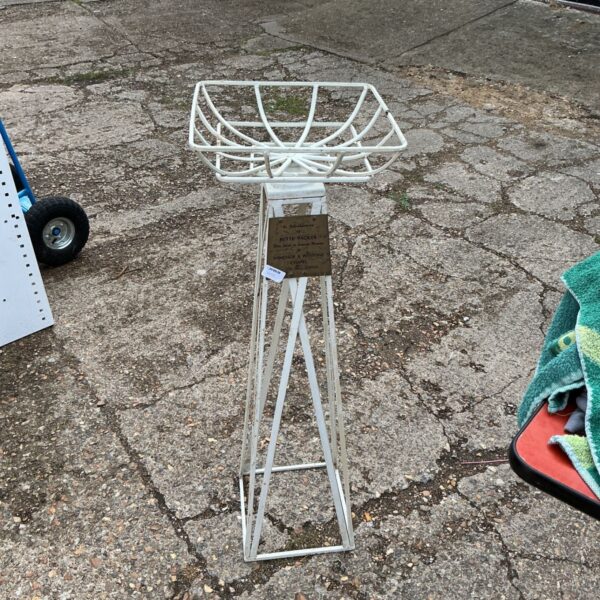 White metal plant stand with square basket, ideal for garden display.