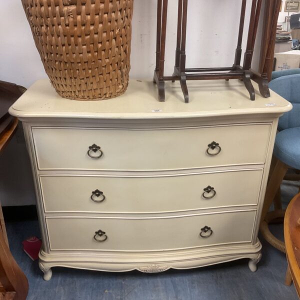 White serpentine chest of drawers, vintage bedroom furniture.
