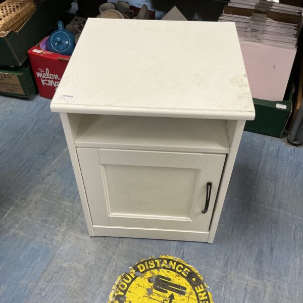 White side table with a single cupboard door, vintage style.