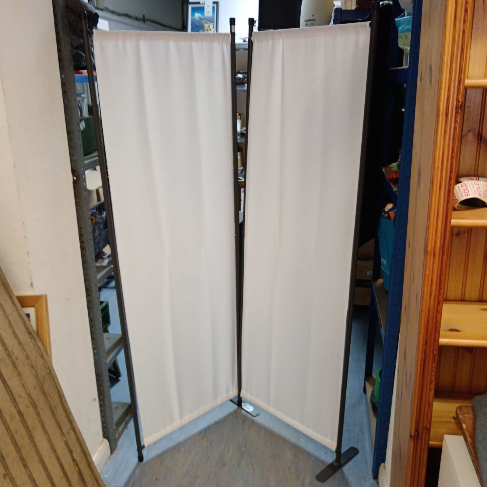 White two-panel privacy screen for room division.
