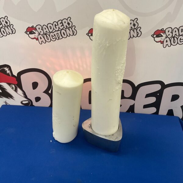 Two large white wax pillar candles for home decoration.