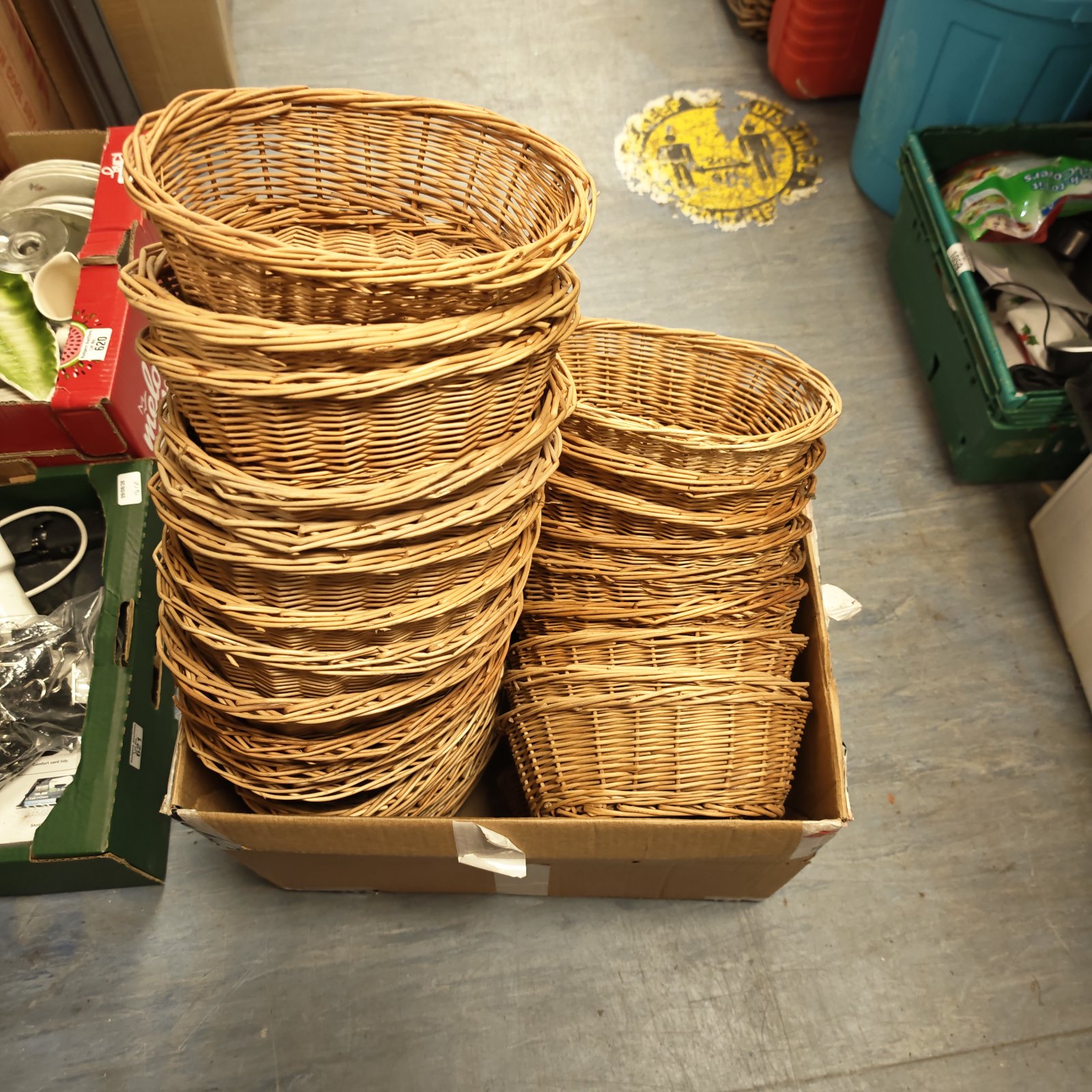 Assorted wicker baskets in a box, rustic storage solution.
