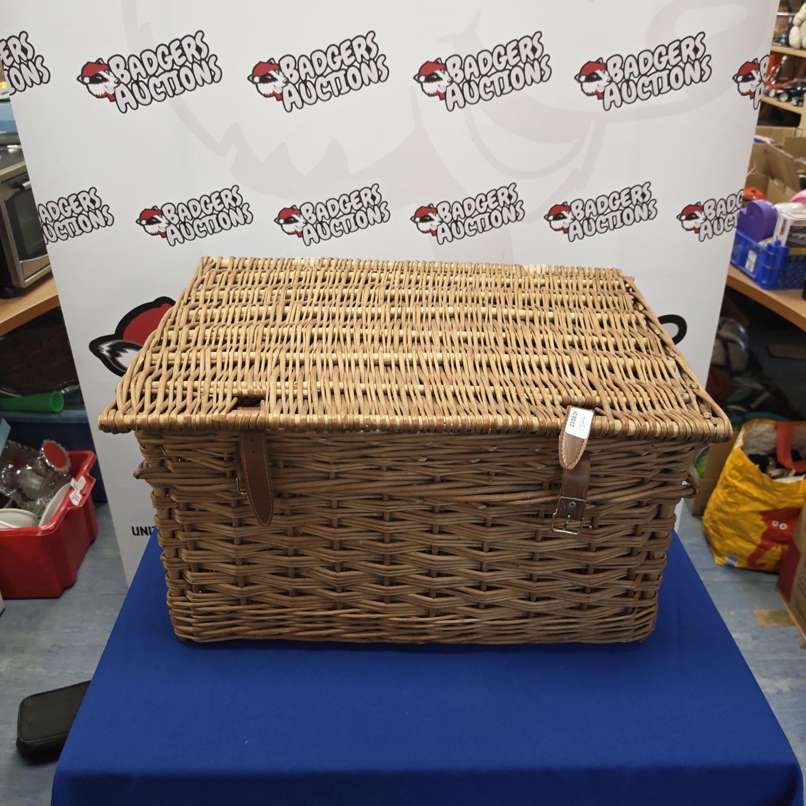 Vintage wicker picnic basket with a sturdy handle.