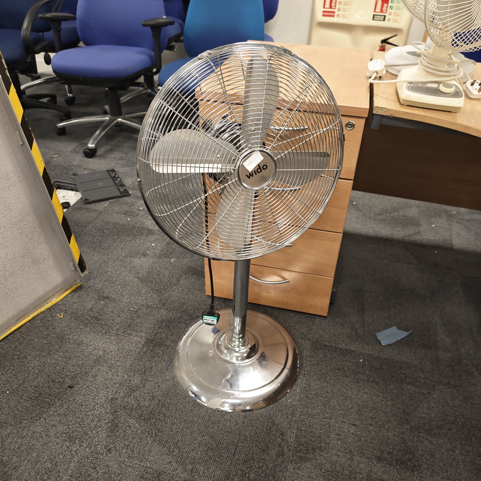 Vintage Wido chrome floor fan in a room setting.