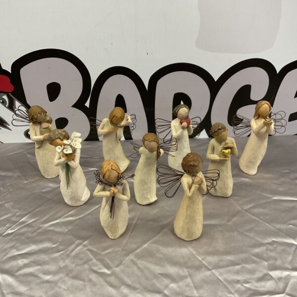 Collection of nine Willow Tree figurines displayed together.