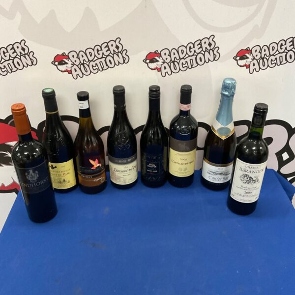 Assorted wine collection including Pinot Noir bottles.