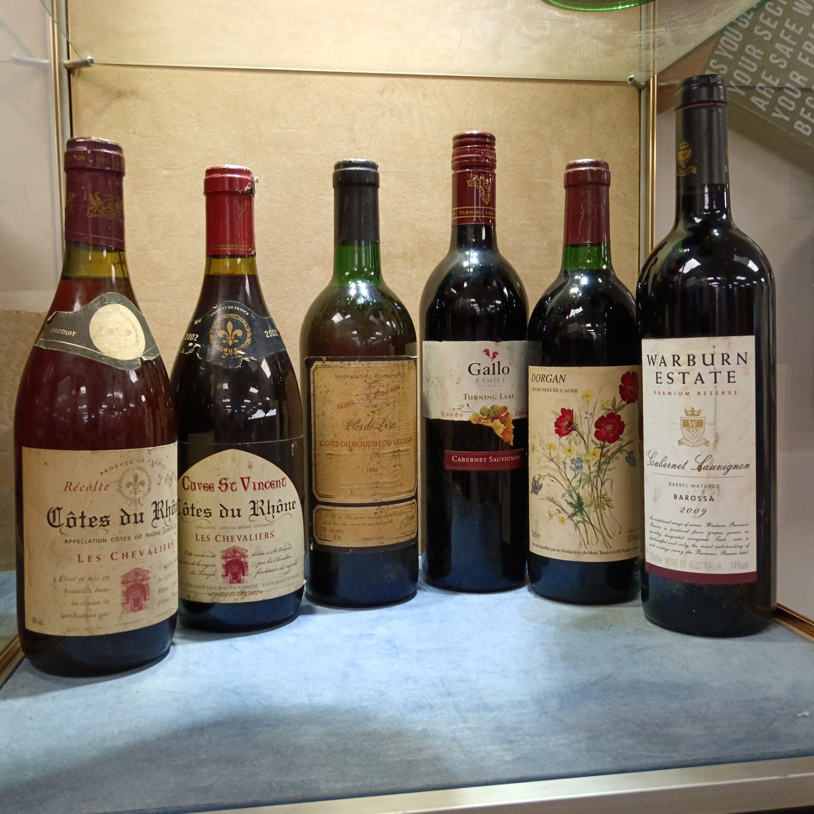 Sealed wine bottles including Cotes du Rhone and Warburn Estate.