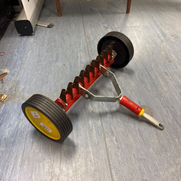 Wolf Garten scarifier attachment with curved blades for lawn care.