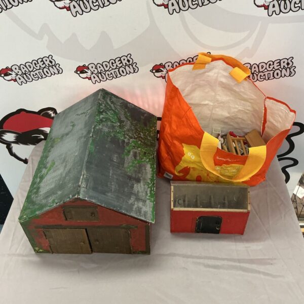 Wooden model barns and accessories in a vintage lot.