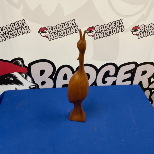 Hand carved wooden bird figurine, a charming folk art piece.