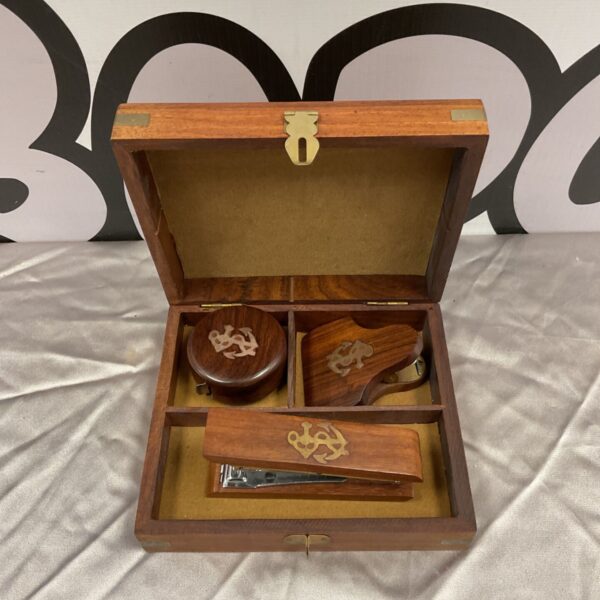 Open wooden nautical desk set with accessories inside.