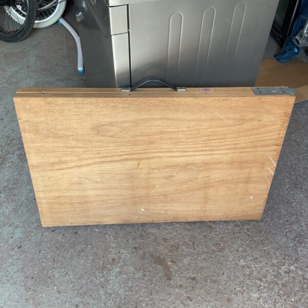 Vintage wooden pasting table for DIY and workshop projects.