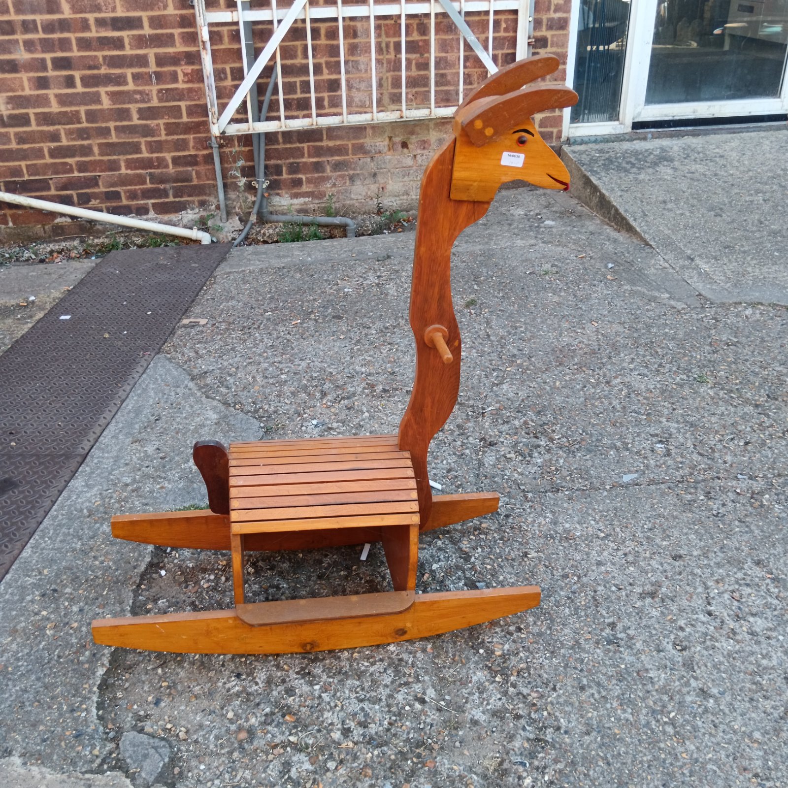 Vintage wooden rocking llama toy for children's nursery.