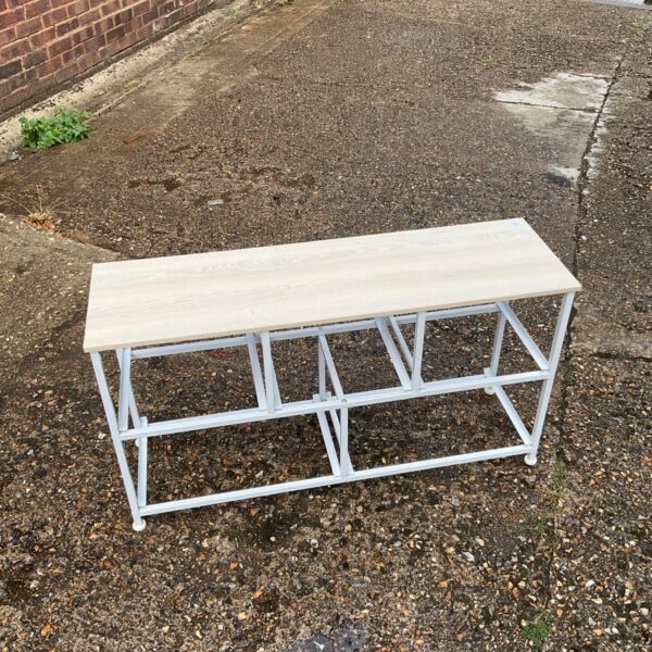 Vintage wooden side table with space for drawers, ideal for storage.