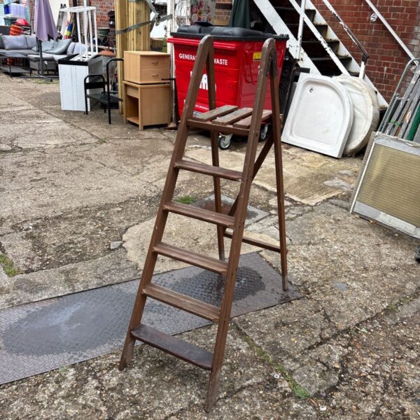 Vintage wooden step ladder with three steps, rustic farmhouse style.
