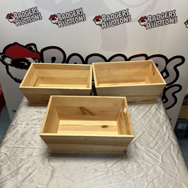 Three rustic wooden trough boxes for garden or home use.