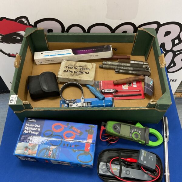 Mixed workshop tool lot with multimeter and various hand tools.