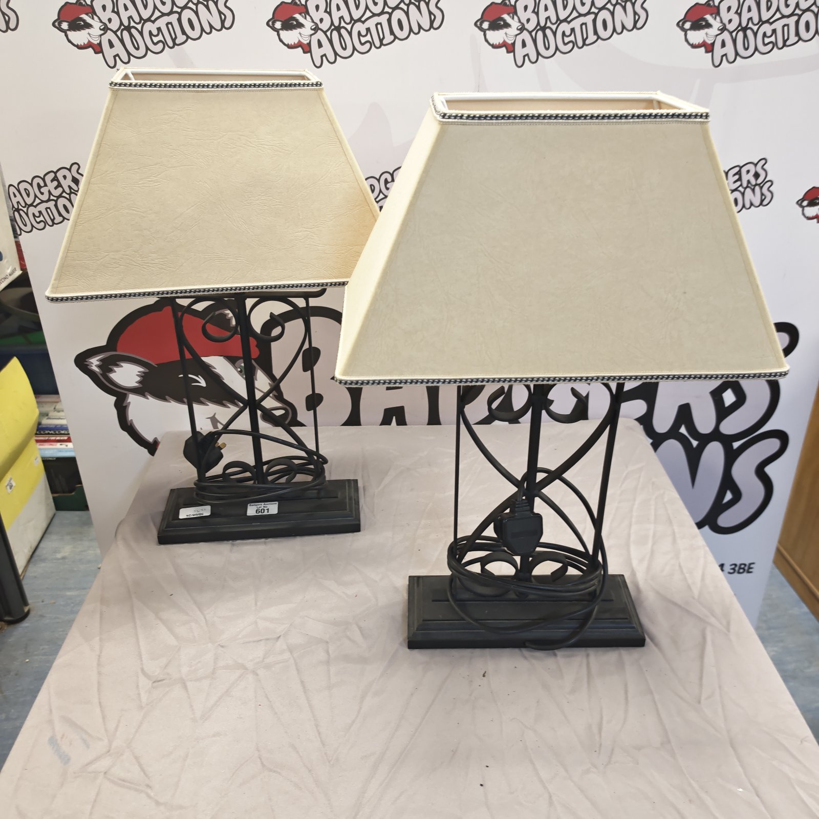 Pair of vintage wrought iron table lamps with cream shades.