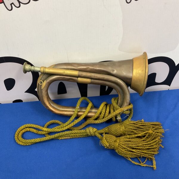 Vintage WWI bugle horn by Henry Potter & Co, side view.