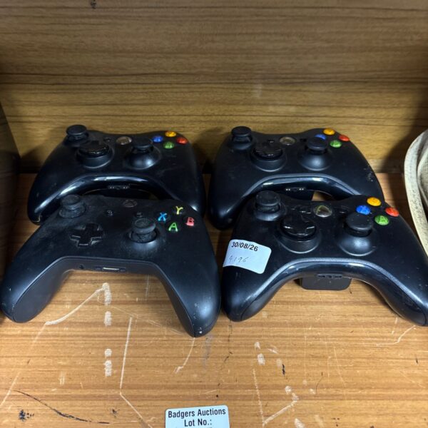 Black Xbox 360 controller for gaming, showing signs of use.