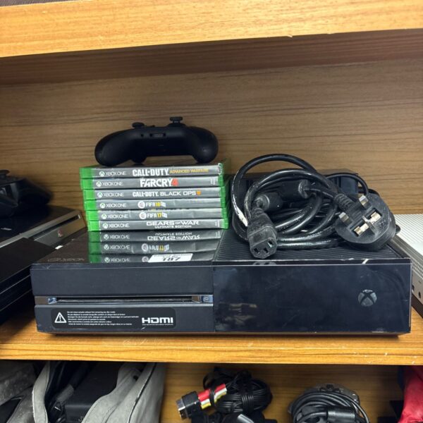 Xbox One console with controller and games displayed for auction.