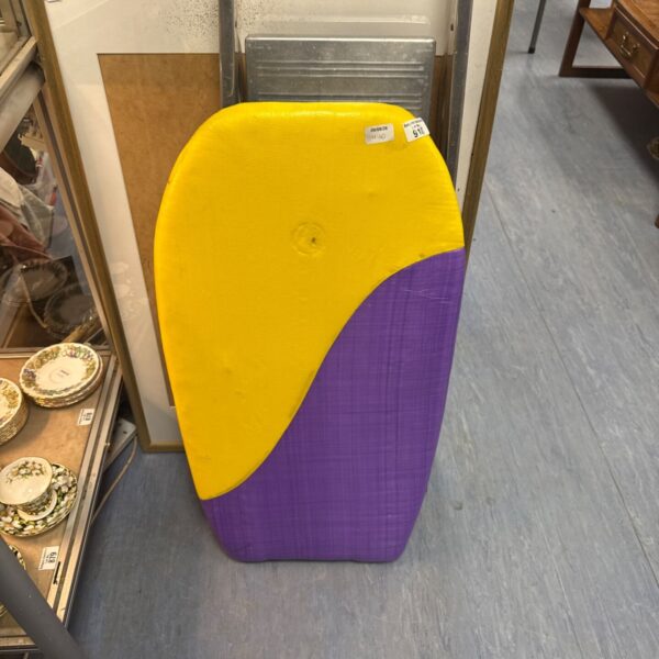 Yellow foam body board for beach and water sports.
