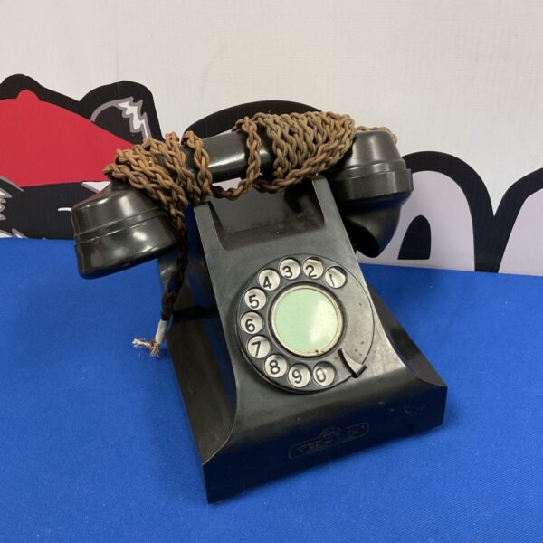 Vintage 1930s Bakelite rotary telephone in dark finish.