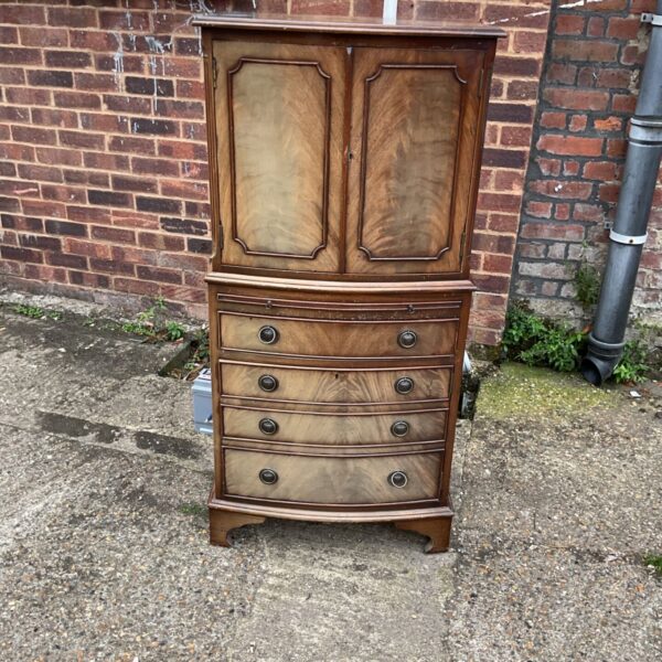Vintage 1970s flame mahogany drinks cabinet for home bar storage.