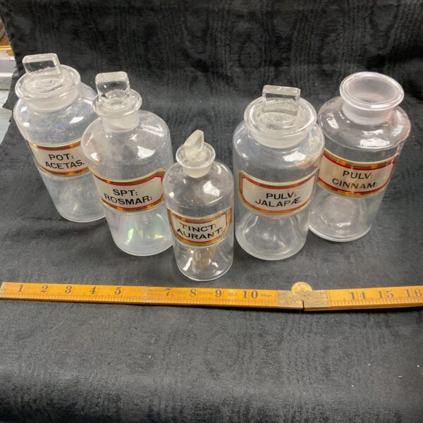 Group of antique 19th-century apothecary jars with labels.