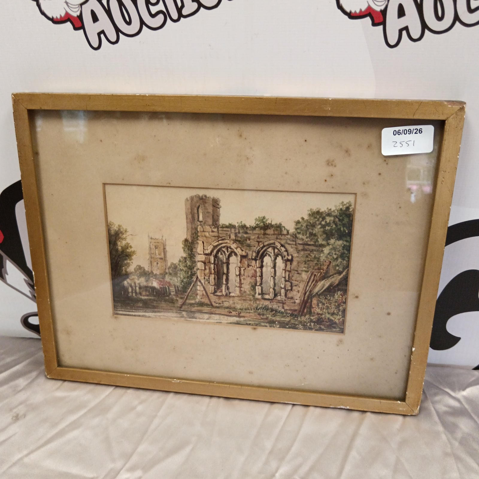 19th century watercolour painting of castle ruins and a church.