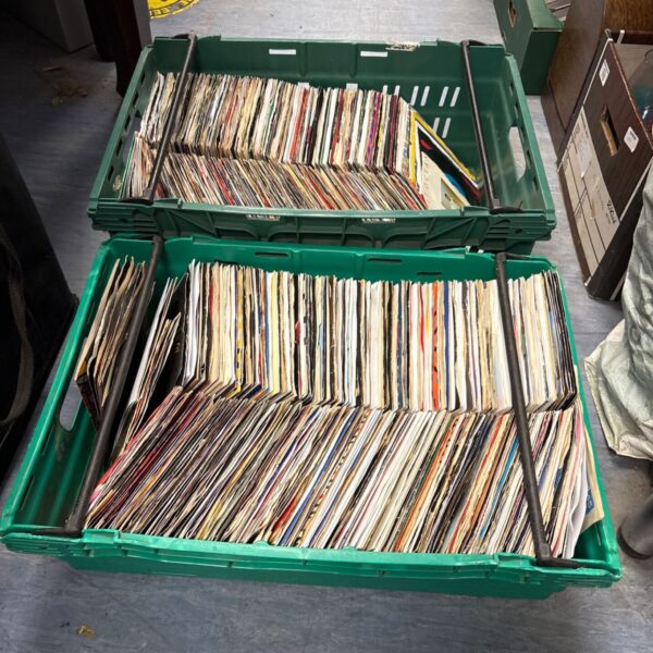 Two crates of mixed 7 inch vinyl records for collectors.