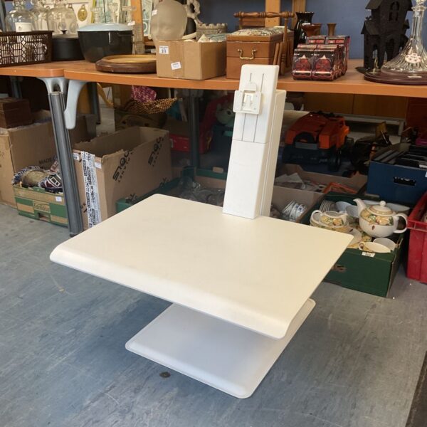 Adjustable desktop riser for a standing workstation setup.