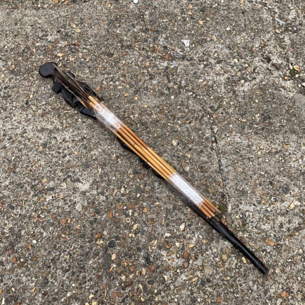 Antique African shaman stick with arrows, ethnographic tribal art.