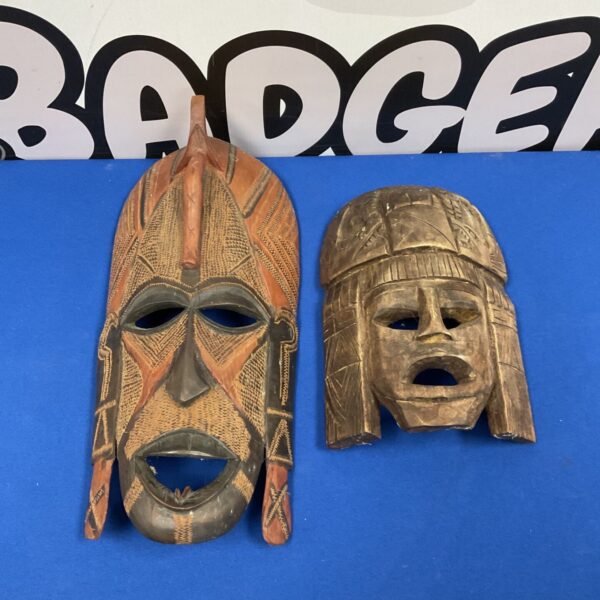Vintage African tribal masks with detailed carvings and geometric patterns.