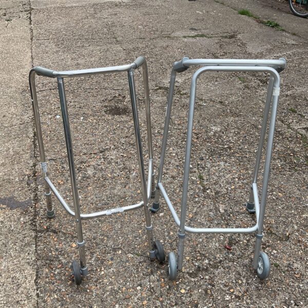 Two aluminium zimmer frames, mobility aids for walking support.