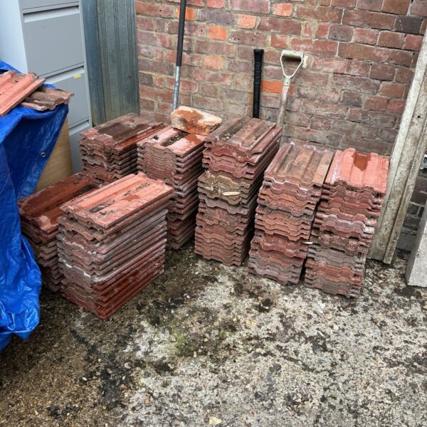 Stack of reclaimed Anchor Vanguard roof tiles for roof renovation.
