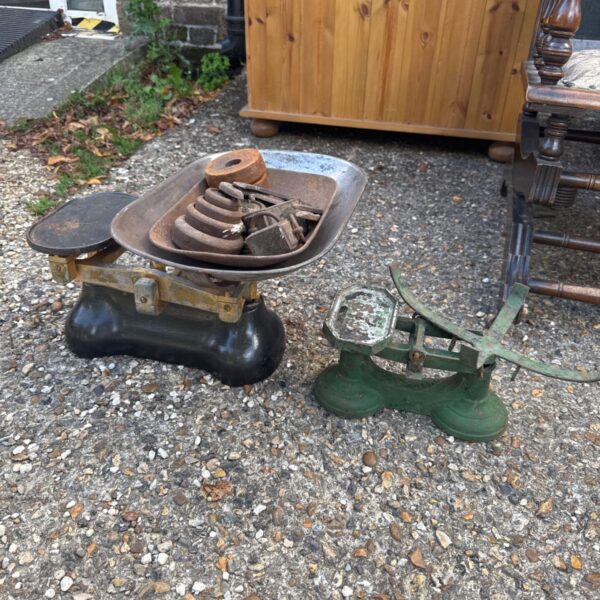 Antique black balance scales with iron weights.