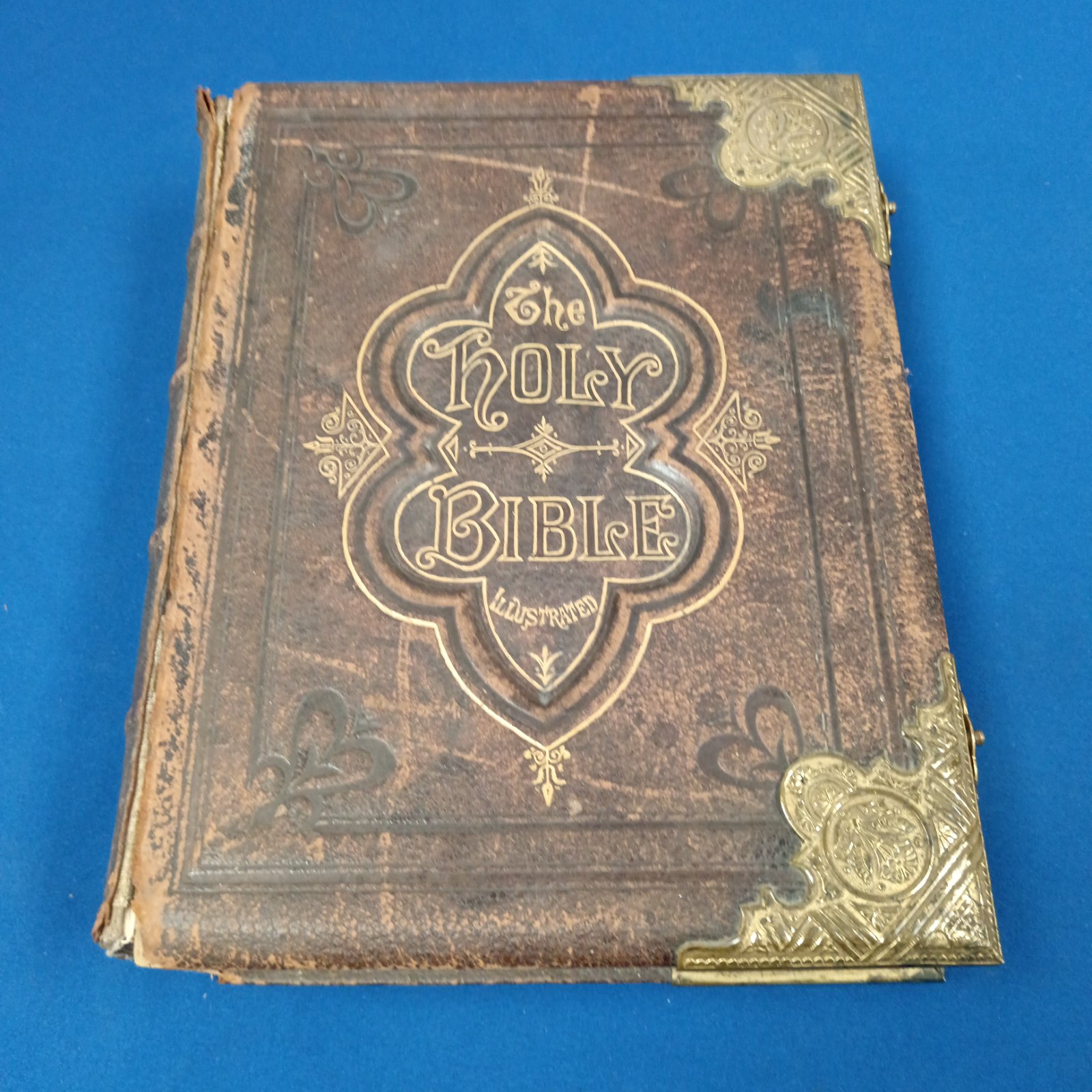 Antique 1897 illustrated Holy Bible cover with gilded details.