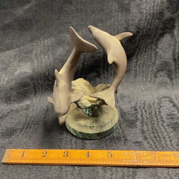 Antique bronze dolphin sculpture on marble base, detailed nautical art.