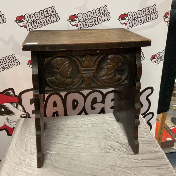 Antique carved oak slipper box with face carvings.