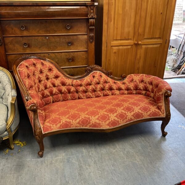 Antique Victorian chaise lounge with red and gold damask upholstery.