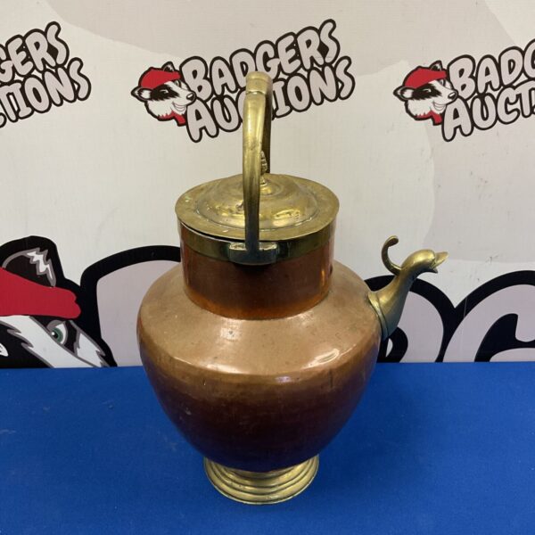 Antique copper kettle with brass lid and duck spout.