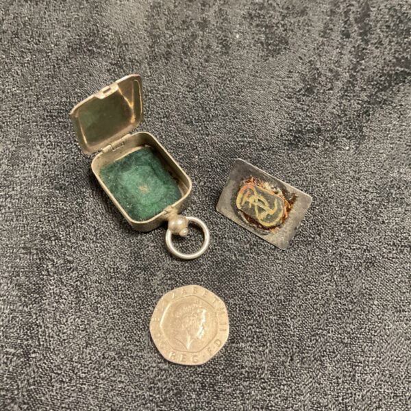 Open antique silver fob seal with green pad inside.