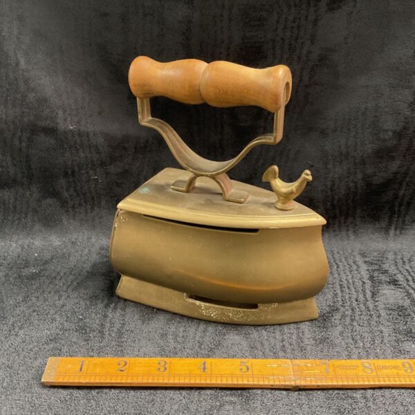 Antique French brass coal iron with wooden handle.
