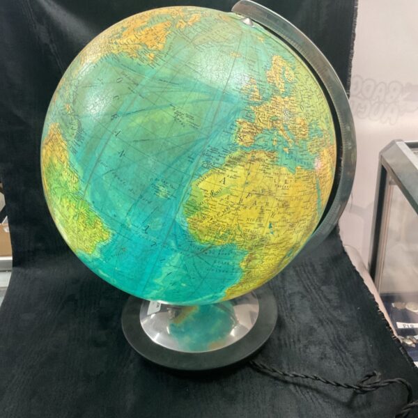 Antique glass map globe with detailed world cartography on a brass stand.