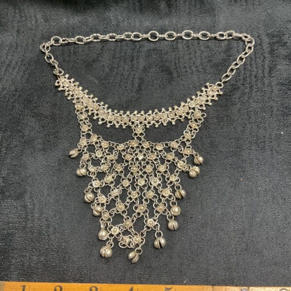 Antique Indian silver necklace with cascading pendants and ornate collar.