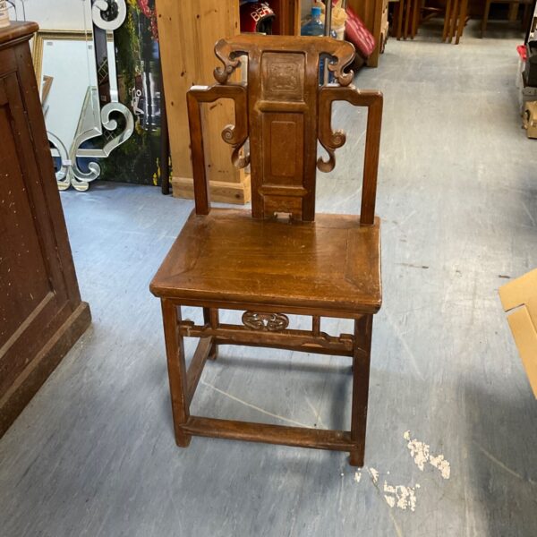 Antique Japanese teak chair with detailed carvings.