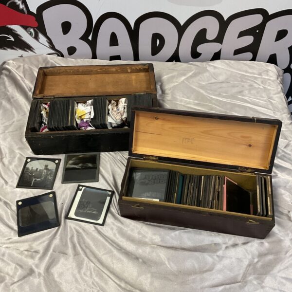 Antique magic lantern slides in wooden boxes, Victorian era collectible.