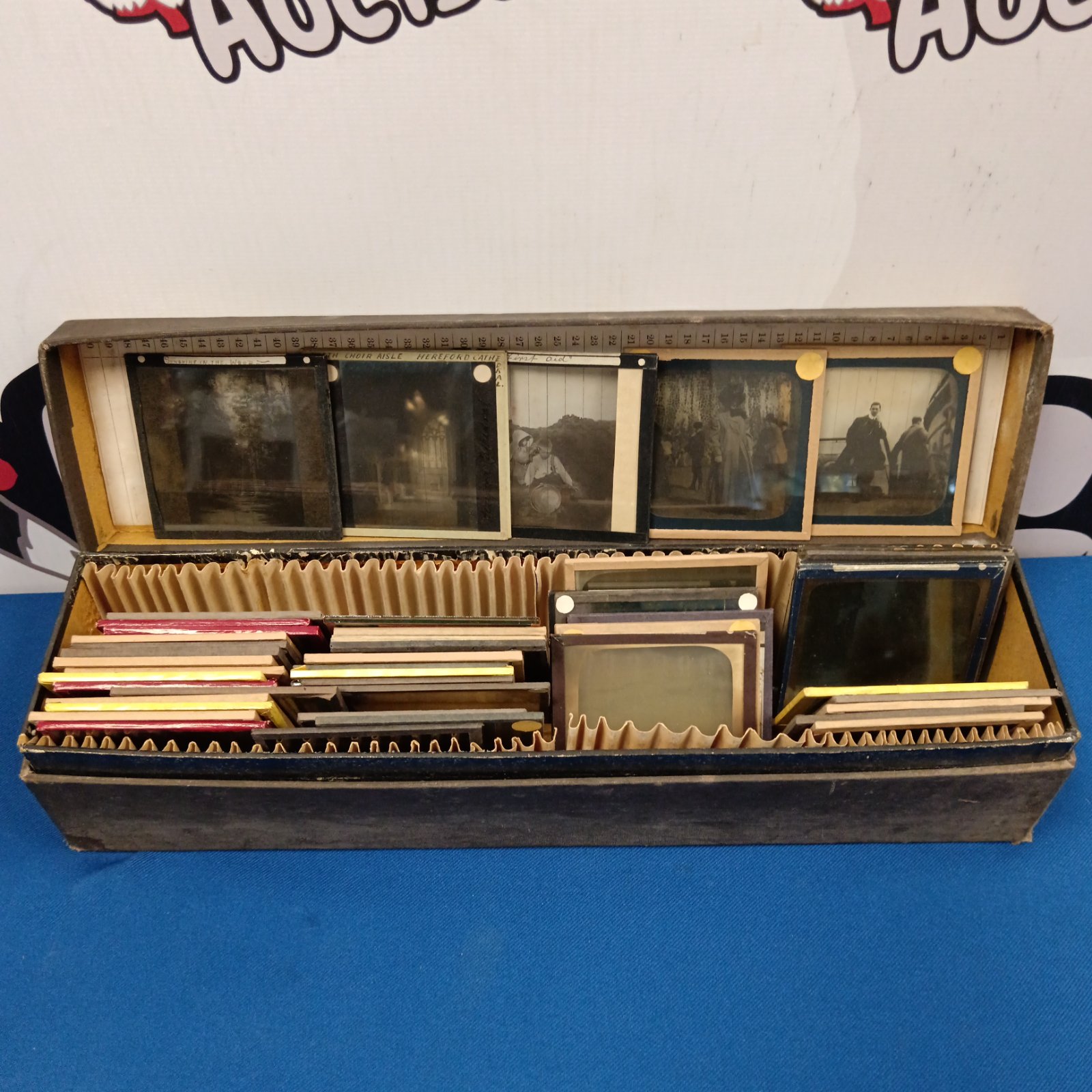 Antique magic lantern slides in wooden case, Victorian era photography.