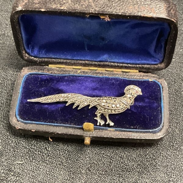 Antique silver pheasant brooch with marcasite detailing in leather box.
